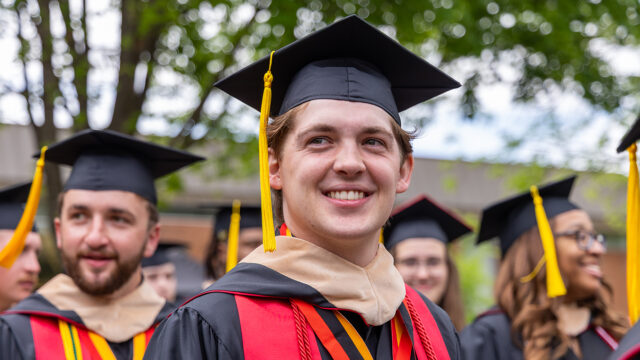 Bridgewater College graduate wearing cap and gown
