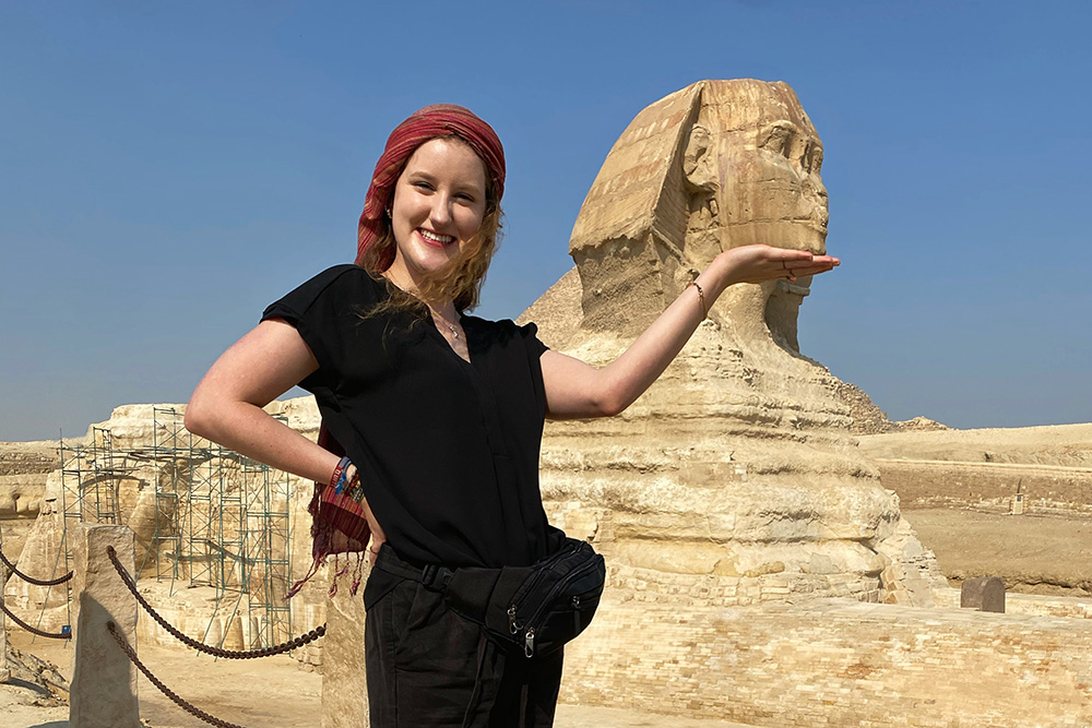 Girl posing in front of the Great Sphinx of Giza