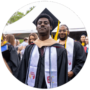 Student at commencement looking proud