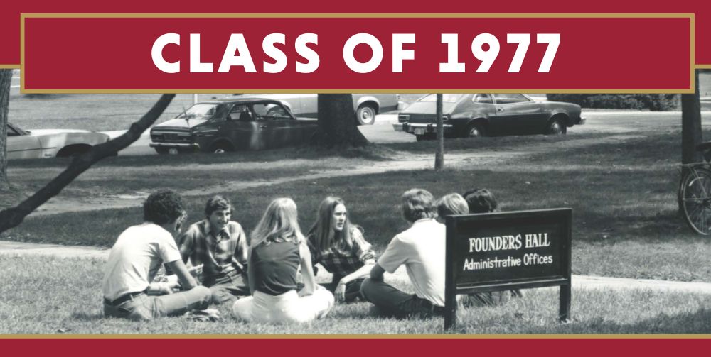 Students sitting in a circle in the grass in 1977