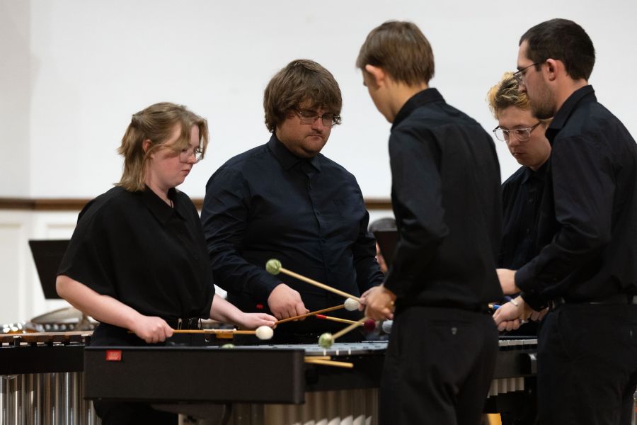 Five students play a Marimba with mallets