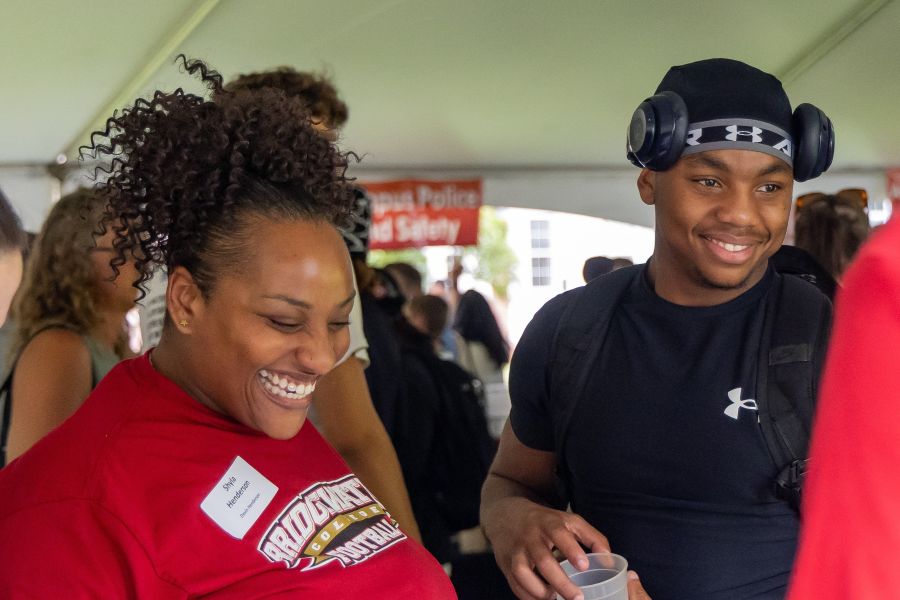 A student and his mother laugh