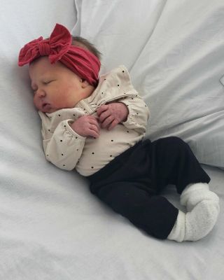 Baby Lainey Joanne Law lies on a gray pillow