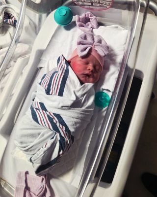 Baby Hallie Paige Johnson lies in a hospital crib