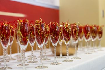 row of Chapagne flutes filled with confetti