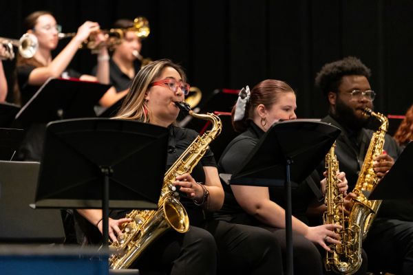 two saxophone players at the front of a jazz band