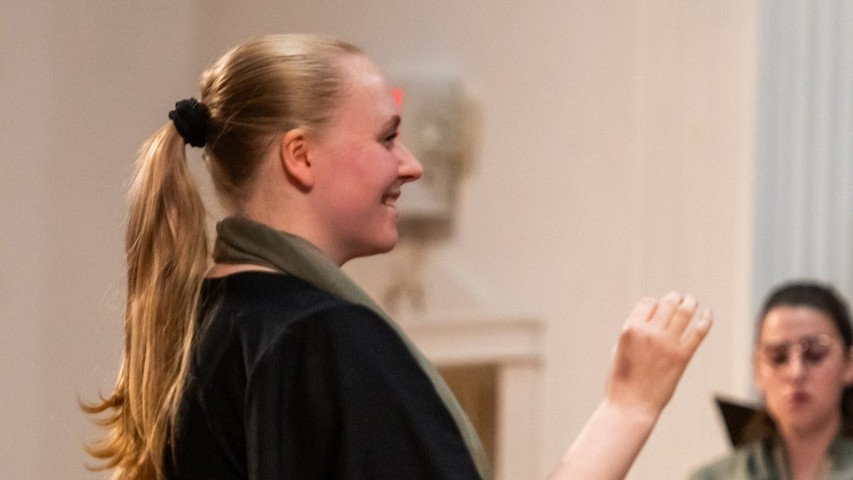 Student Hannah Simmers conducts the world premiere of one of her original works.