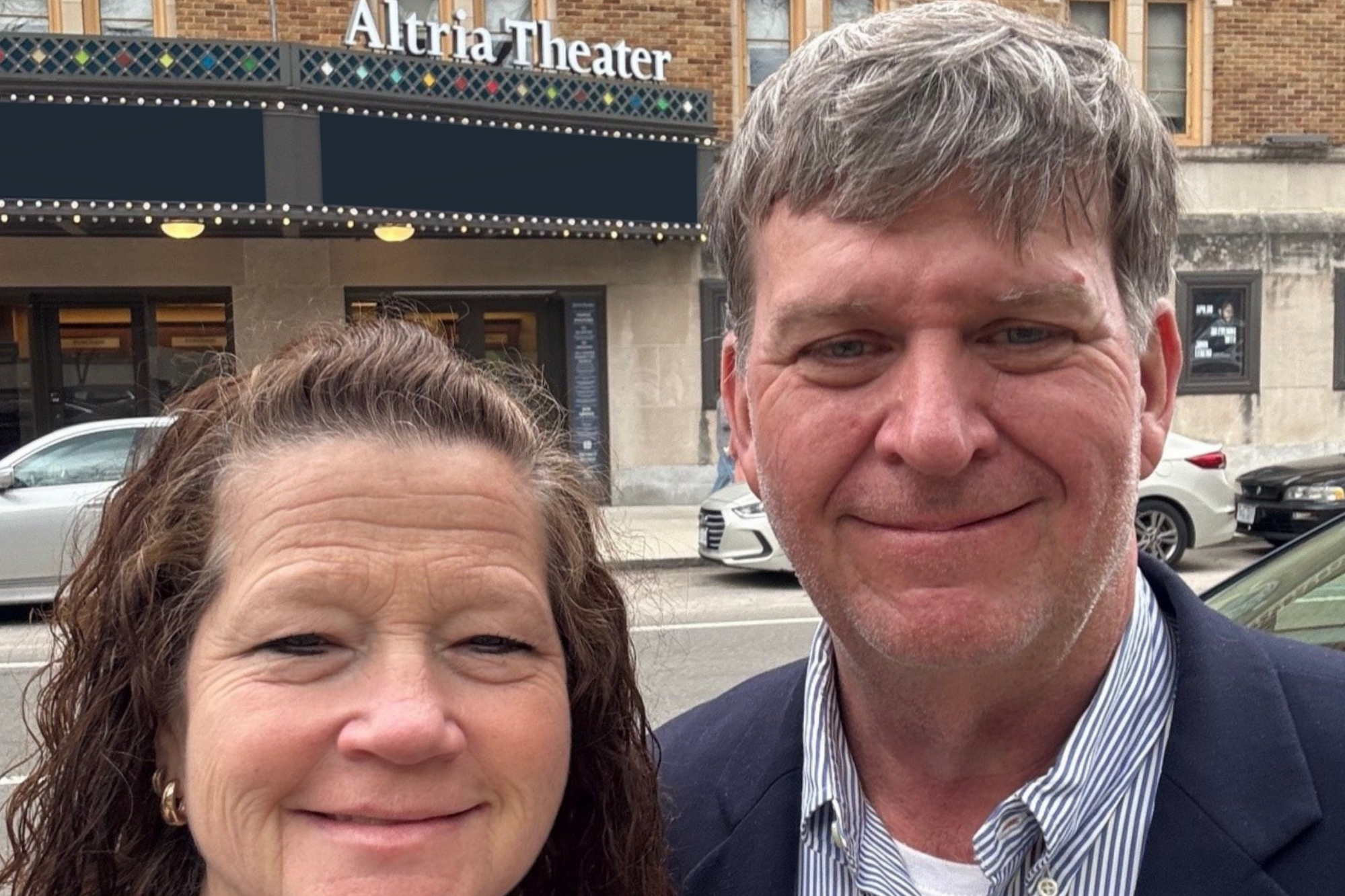 Two bridgewater alumni take a selfie in front of the Altria Theater