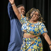 Two student models dance at afro-fest